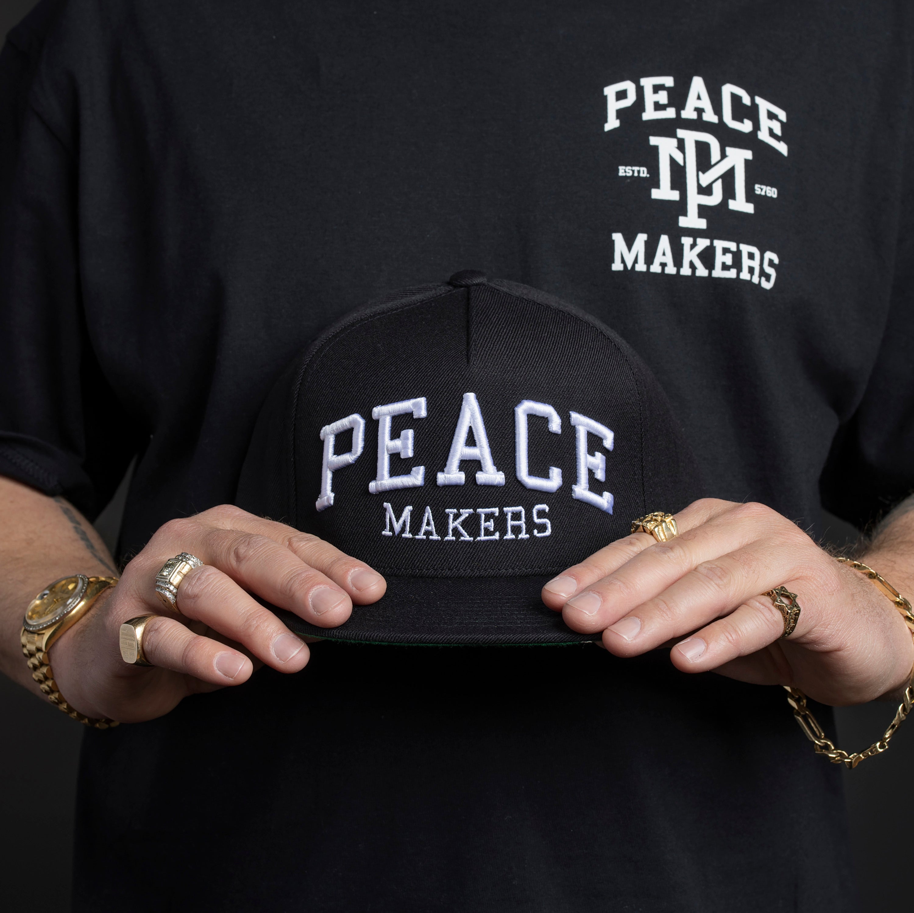 Our Peace Makers Hat is a statement of unity, purpose, and style. This Premium Five-Panel Snapback Cap is built on a classic Yupoong 5-panel pinch front, offering a timeless fit that suits most head sizes comfortably. Whether you're repping peace on the streets or just adding a clean, versatile piece to your wardrobe, this hat delivers.
Pair it with our Peace Makers Tees, Hoodies, and Sweats for the ultimate look—because spreading peace isn’t just a mindset, it’s a movement.