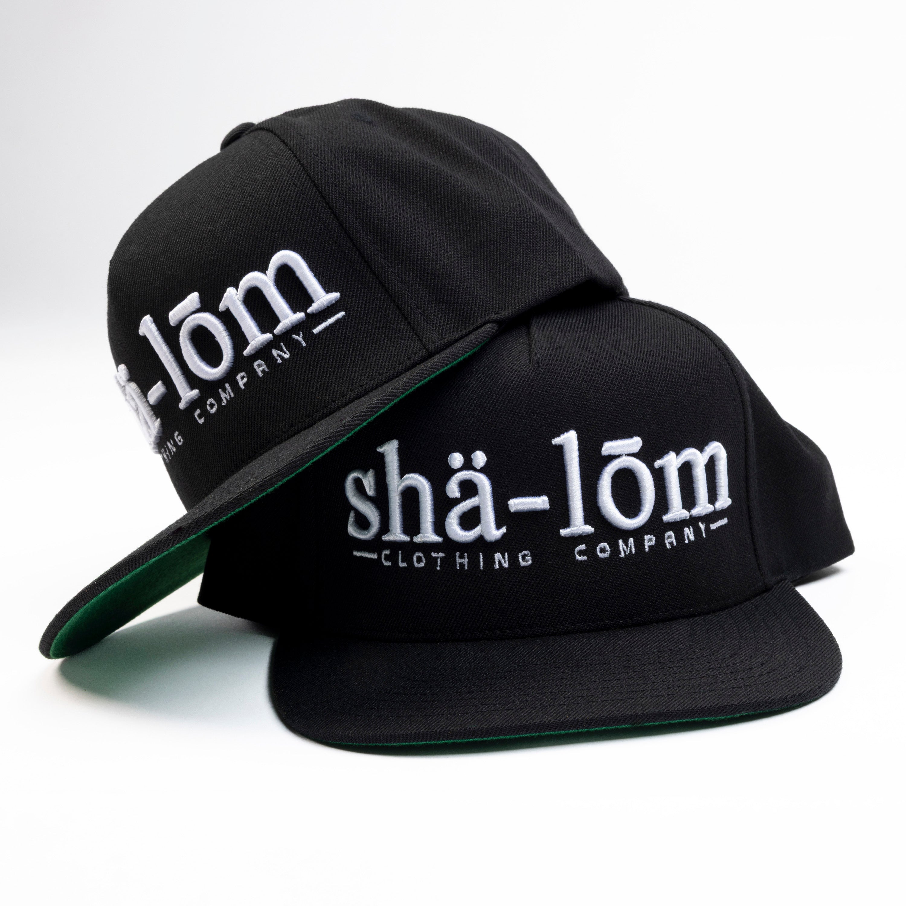 Our Shalom Definition Hat is a bold yet timeless way to represent peace. This Premium Five-Panel Snapback Cap is built on a classic Yupoong 5-panel pinch front, ensuring a perfect fit for most head sizes. With a clean, structured design, it’s a versatile piece that speaks volumes.
